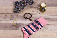 A SprezzaBox monthly subscription box featuring a watch, tie, socks, and a wooden comb for men's accessories