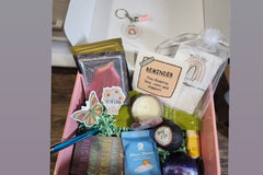 There will be a pen and journal as well as a soft smelling candle. Each box will have a different scent candle.