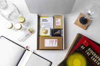 An open Matter subscription box showcasing a space blanket and various science artifacts for the endlessly curious mind