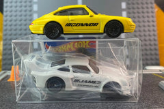 The Hot Wheels monthly subscription box containing a personalized car with name, display case, additional new cars, and accessories.