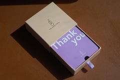 A thejewelpick gift card in a The Jewel Pick box on a table.