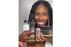 A smiling girl with thriving locs holding a selection of products that were included in her Loc Box from Her Crown and Glory 