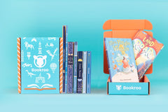 Two children reading books from Bookroo's Tween Book Club subscription on a colorful rug with additional books nearby