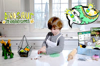 Two children engaged in the I'm The Chef Too! cooking kit, creating galaxy donuts with colorful icing and sprinkles
