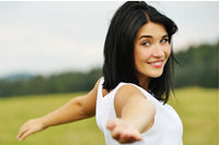 w fair skinned woman with black, short hair and green eyes is smiling with her arms help out in a t position. 