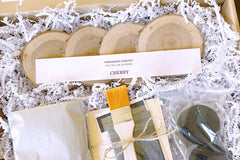 An open Crate Club box displaying 4 cherry wood coasters, sealants, an applicator brush, and other box ingredients.