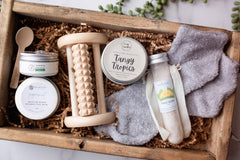 "An array of self-care items designed for foot pampering, including a pair of cozy spa socks. Features a variety of items such as foot soaks