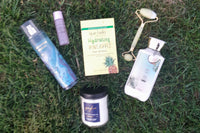 various bath and body works products, jade roller, peel of mask and bath and body works gigham candle.