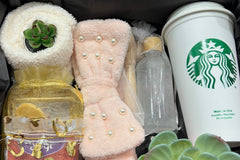 Our December Box: Relax and Stay Warm - Your Winter Sanctuary. Warmth awaits with headband, oils, socks, cup, and tea.