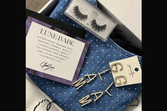 Glam Luxe Box filled with diamond drop glam earrings, full wispy eye lashes, and medium diamond denim dress.