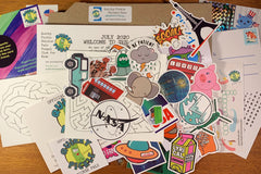 Picture shows actual contents of a Quirky Pickle pack from July 2020, with stickers, activity sheets, stationery, and instructions.