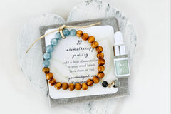 Blue Stone and Wood Diffuser Bracelet with Lava Charm in White Gift Box with Aromatherapy Instruction Card and Faux Fir Mini Oil Dropper.