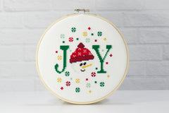 counted cross stitch of the month club for DIY crafting of snowman joy with colorful snowflakes for christmas decor