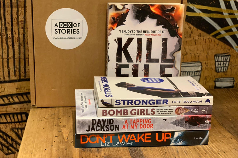 Brown subscription box filled with four surprise mystery books, featuring captivating stories and intriguing plots for genre enthusiasts.