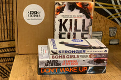 Brown subscription box filled with four surprise mystery books, featuring captivating stories and intriguing plots for genre enthusiasts.