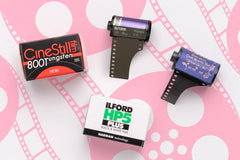 Example film bundle.  Four films shown on pink patterned background. Brands shown: CineStill, Ilford, Atlanta Film Co.