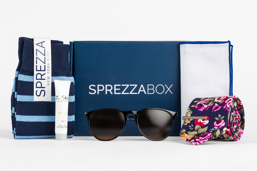 A SprezzaBox monthly subscription box featuring a watch, tie, socks, and a wooden comb for men's accessories