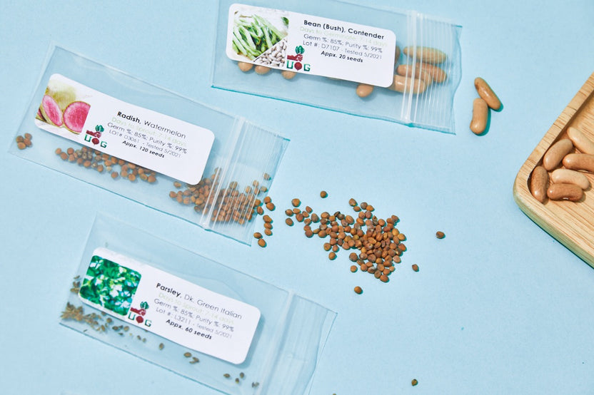 Seed packets and planting materials from the Urban Organic Gardener's Monthly Seed Club subscription box for gardening enthusiasts