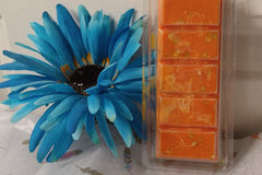 A Lavish Luxury Bath and Body Box with orange and blue soap featuring a flower.