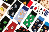 Many socks from the Say it with a Sock subscription box, laid out neatly. There are shark, baseball, soccer and frog socks.