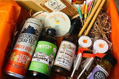 box filled with spicy food items to celebrate the Summer months and includes hot sauce, t-shirt, spicy sweets and condiments. 