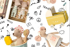 Items from a Why and Whale, including several stuffed mice and a pram and a bathtub.