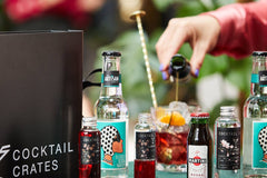 Cocktail subscription box from Cocktail Crates being enjoyed by a cocktail lover, making the negroni cocktail 