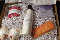 A Lavish Luxury Bath and Body Box filled with soap, lotion, and other items.