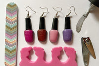 Colorful assortment of unique earrings including food and whimsical designs in the Monthly Earring Mania subscription box