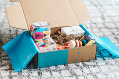 An open Hoppi subscription box filled with high quality toys to support your little one’s development and imagination.