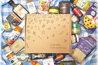 A Culinarie LUXE box surrounded by cooking ingredients. The box is decorated with illustrations of ingredients and cooking utensils.