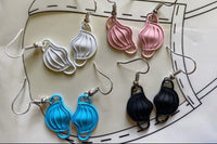 Colorful assortment of unique earrings including food and whimsical designs in the Monthly Earring Mania subscription box