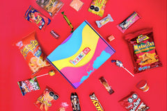 Pachanga Box with red background with some of the Colombian snacks featured in the Colombia edition.  