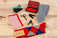 A SprezzaBox monthly subscription box featuring a watch, tie, socks, and a wooden comb for men's accessories