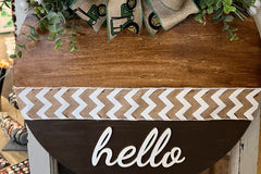 A large round welcome wall hanging. This comes with a set of 3 bows that are magnetic and can be changed out with the seasons. 