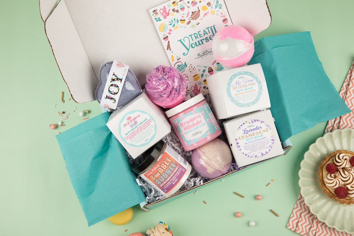 Treat Yourself Bath Bevy Subscription box with bath bombs, whipped soap scrub, bubble rubble against a light green background