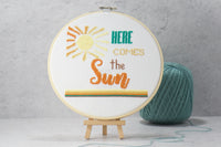 here comes the sun counted cross stitch pattern with colorful words and aztec style sun with varied shades of gold