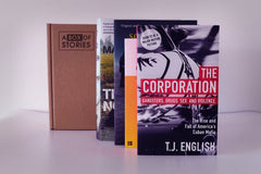 Brown subscription box filled with four light reading books, featuring charming stories and uplifting themes for easygoing book lovers.