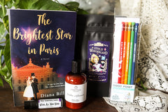A red mug filled with three packets of Moonstruck milk chocolate, featured in the Peace & Pages monthly subscription box