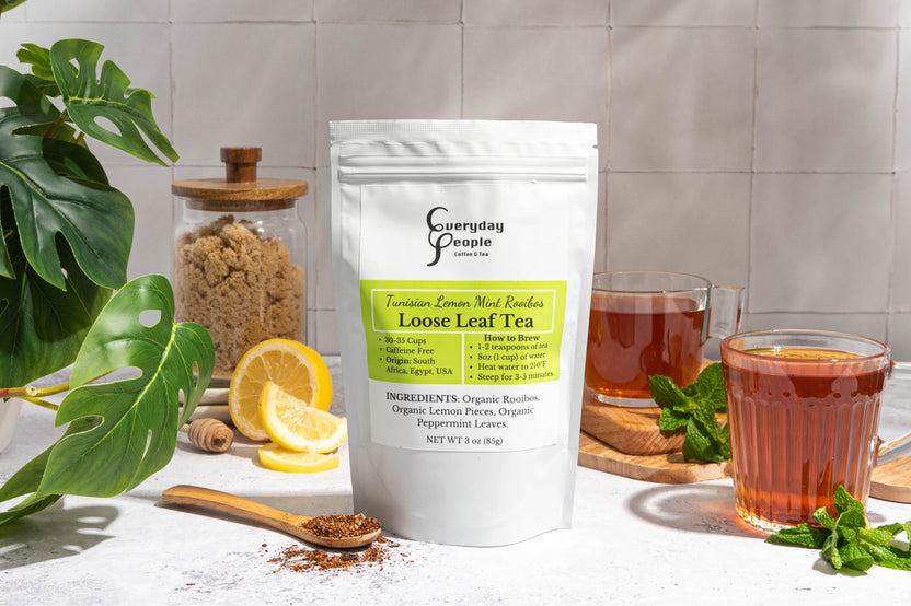 A gift bag of Everyday People Coffee & Tea's Great Tasting Sustainably Grown and Ethically Sourced Loose Leaf Tea Subscription on a table.