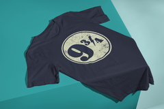 A dark blue Harry Potter iconic Platform 9 3/4 Tshirt laying on a display table with the bottom draping over a corner.