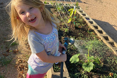 Watering the school garden, including squash, Spicewood Elementary, Austin Texas, photo credit to Stephanie Facey