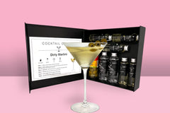 A Cocktail subscription box displaying a negroni cocktail in front of a gift box from Cocktail Crates