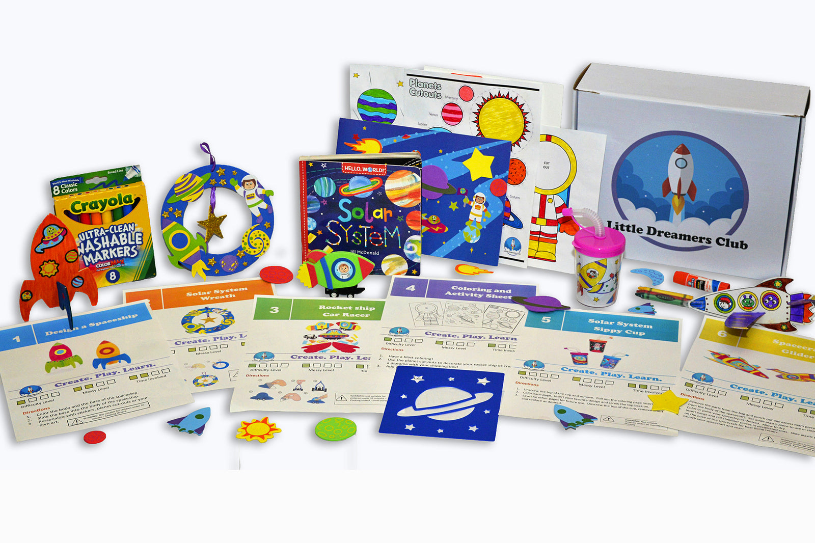 "Little Dreamers Club box with solar system themed crafts, book, art supplies, a DIY project, a sticker scene, and coloring pages."