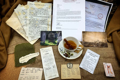 Tea cup, ships ticket, photo, letters, photocopied documents, cigarette card, scrap notes and a coin and postcard