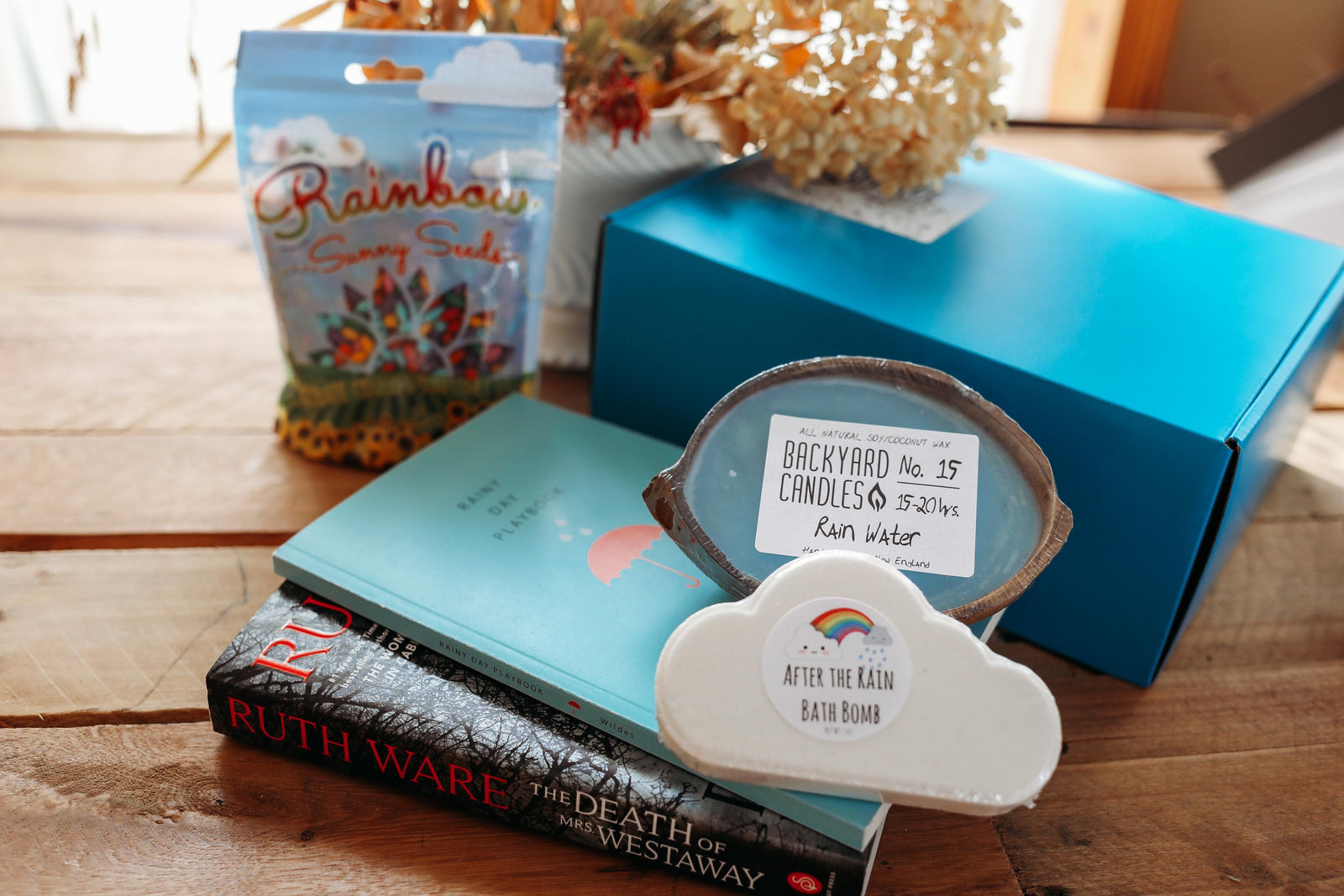 A red mug filled with three packets of Moonstruck milk chocolate, featured in the Peace & Pages monthly subscription box
