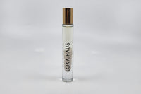 Tall bottle with gold cap: LOKA.HAUS's 'Intensity Parfum Roller'. Luxurious scent, crystal clarity. Elegance rolls on.